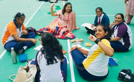 Abanita engaging with students in a group setting